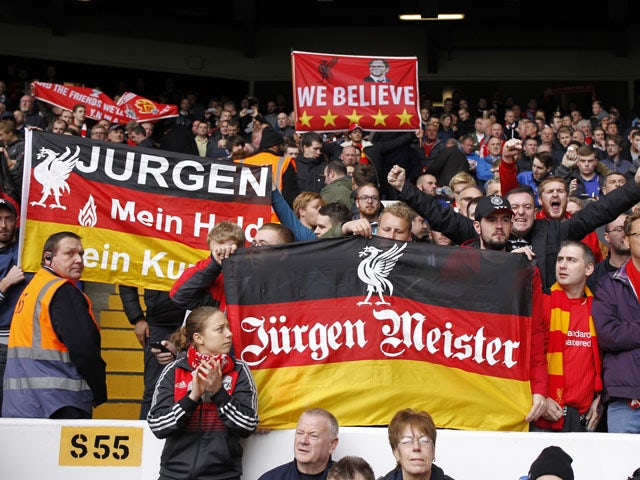 Liverpool supporters hold up banners in support of their new manager, Liverpool's German manager Jurgen Klopp ahead of the English Premier League football match between Tottenham Hotspur and Liverpool at White Hart Lane in north London on October 17, 2015