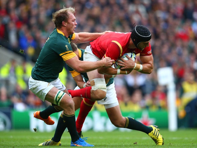 Luke Charteris of Wales is tackled by Adriaan Strauss of South Africa and Handre Pollard of South Africa during the 2015 Rugby World Cup Quarter Final match between South Africa and Wales at Twickenham Stadium on October 17, 2015