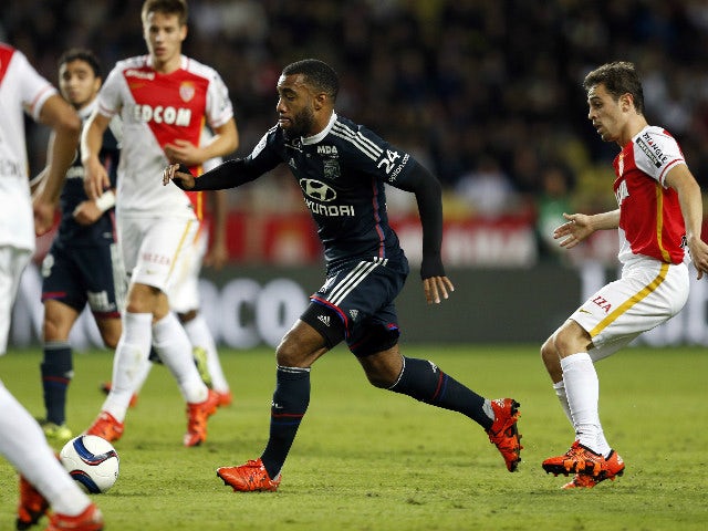 Lyon's French forward Alexandre Lacazette vies with Monaco's Croatian midfielder Mario Pasalic (R) during the French L1 football match between Monaco (ASM) and Lyon (OL) on October 16, 2015 at the Louis II Stadium in Monaco