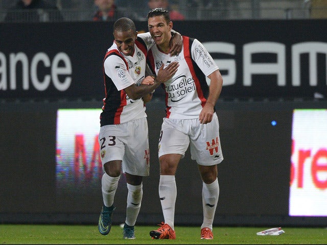 Nice's French forward Hatem Ben Arfa (R) celebrates with his teammate Nice's Portuguese defender Ricardo Pereira after scoring a goal during the French L1 football match between Rennes and Nice on October 18, 2015