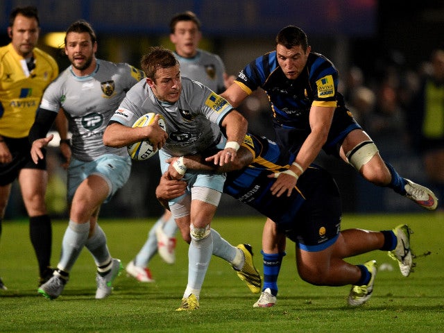 Stephen Myler of Northampton is tackled by Na'ama Leliemalefaga of Worcester during the Aviva Premiership match between Worcester Warriors and Northampton Saints at Sixways Stadium on October 16, 2015 in Worcester, England.