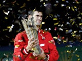 Novak Djokovic of Serbia poses with the winner's trophy after defeating Jo-Wilfried Tsonga of France during the men's singles final match of the Shanghai Rolex Masters at the Qi Zhong Tennis Center on day 8 of Shanghai Rolex Masters at Qi Zhong Tennis Cen