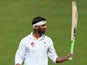 Shoaib Malik of Pakistan celebrates reaching his double century during Day Two of the First Test between Pakistan and England at Zayed Cricket Stadium on October 14, 2015 in Abu Dhabi, United Arab Emirates.