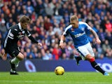 Martyn Waghorn of Rangers takes on Jake Pickard of Queen of the South during the Scottish Championship match between Glasgow Rangers FC and Queen of the South FC at Ibrox Stadium on October 17, 2015 