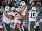 Ryan Fitzpatrick #14 of the New York Jets picks up Eric Decker #87 as he is congratulated by his teammates after scoring a third quarter touchdown against the Washington Redskins at MetLife Stadium on October 18, 2015