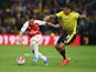 Santi Cazorla of Arsenal and Troy Deeney of Watford compete for the ball during the Barclays Premier League match between Watford and Arsenal at Vicarage Road on October 17, 2015 in Watford, England.