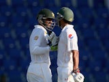 Shoaib Malik is congratulated by Younis Khan after reaching his 100 on day one of the first Test against England in Abu Dhabi on October 13, 2015