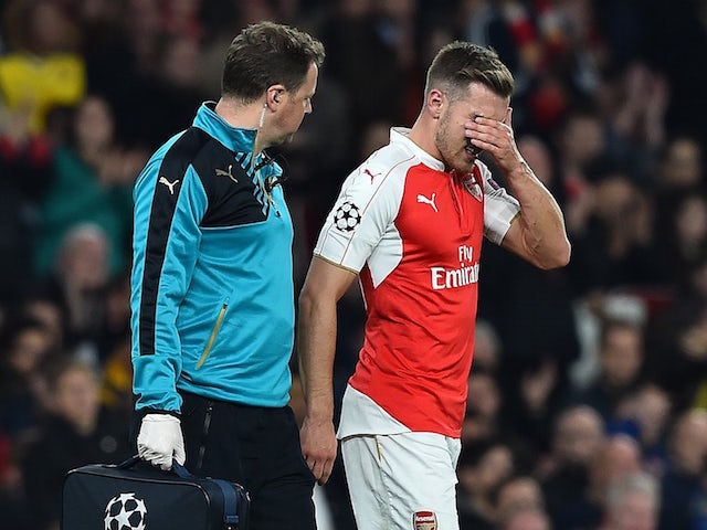 Arsenal's Welsh midfielder Aaron Ramsey (R) leaves the pitch injured during the UEFA Champions League football match between Arsenal and Bayern Munich at the Emirates Stadium in London, on October 20, 2015.
