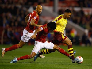 Andre Gray of Burnley battles with Ryan Mendes of Nottingham Forest during the Sky Bet Championship match between Nottingham Forest and Burnley at City Ground on October 20, 2015 in Nottingham, England.