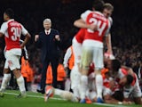 Arsenal's French manager Arsene Wenger (2L) reacts as his players celebrate Arsenal's German midfielder Mesut Ozil goal during the UEFA Champions League football match between Arsenal and Bayern Munich at the Emirates Stadium in London, on October 20, 201