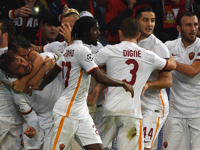 Roma´s players celebrate scoring during the Group E, first-leg UEFA Champions League football match Bayer Leverkusen vs AS Roma in Leverkusen, western Germany on October 20, 2015.