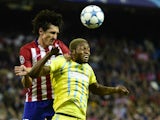 Astana's Congolese forward Junior Kabananga (R) vies with Atletico Madrid's Montenegrin defender Stefan Savic during the UEFA Champions League group C football match Club Atletico de Madrid vs FC Astana at the Vicente Calderon stadium in Madrid on October