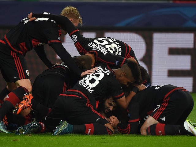 Leverkusen´s players celebrate scoring during the Group E, first-leg UEFA Champions League football match Bayer Leverkusen vs AS Roma in Leverkusen, western Germany on October 20, 2015. 
