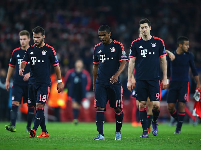 Juan Bernat (18), Douglas Costa (11) and Robert Lewandowski of Bayern Munich (9) look dejected in defeat after the UEFA Champions League Group F match between Arsenal FC and FC Bayern Munchen at Emirates Stadium on October 20, 2015 in London, United Kingd