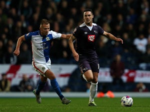 Jordan Rhodes (L) of Blackburn Rovers in action with Jason Shackell of Derby County during the Sky Bet Championship match between Blackburn Rovers and Derby County at Ewood Park on October 21, 2015 in Blackburn, England.