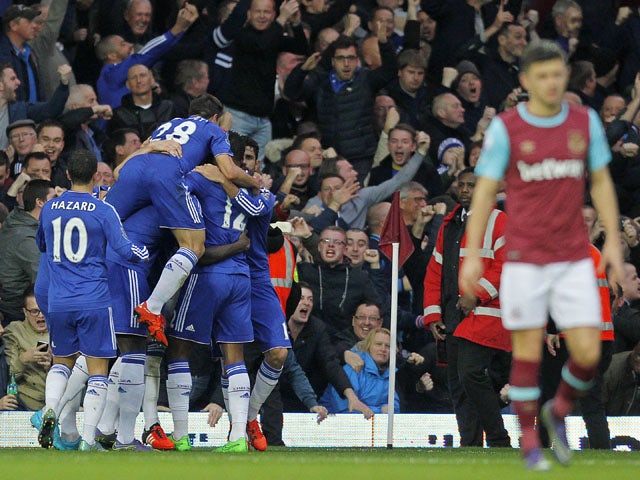 Chelsea's players (L) celebrate the goal of Chelsea's English defender Gary Cahill during the English Premier League football match between West Ham United and Chelsea at The Boleyn Ground in Upton Park, east London on October 24, 2015
