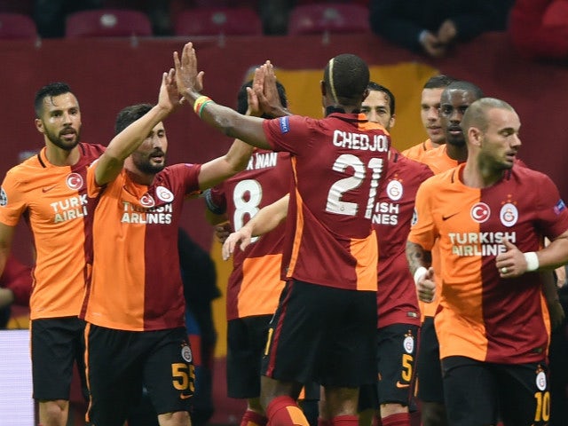 Galatasaray players celebrate after Galatasaray's German forward Lukas Podolski scored the second goal during the UEFA Champions League football match between Galatasaray AS and SL Benfica at the Ali Sami Yen Spor Kompleks stadium in Istanbul on October 2