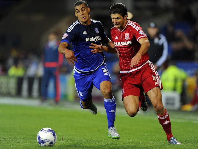 George Friend of Middlesbrough is tackled by Lee Peltier of Cardiff City during the Sky Bet Championship match between Cardiff City and Middlesbrough at the Cardiff City Stadium on October 20, 2015 in Cardiff, Wales. 