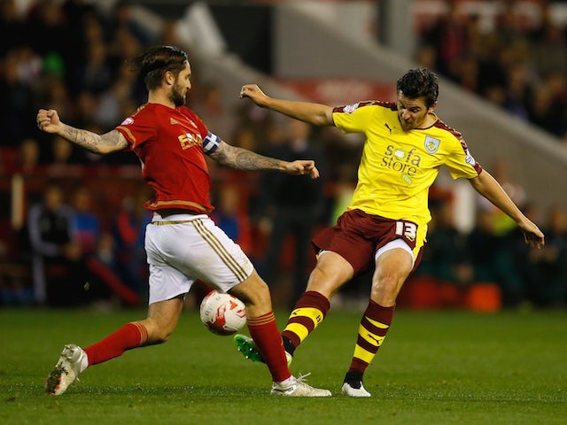 Joey Barton of Burnley tackles Henri Lansbury of Nottingham Forest during the Sky Bet Championship match between Nottingham Forest and Burnley at City Ground on October 20, 2015 in Nottingham, England. 