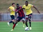 Ajaccio's Guinean defender Issiaga Sylla (L) vies with Sochaux's French midfielder Karl Toko Ekambi (R) during the friendly football match Sochaux (FCSM) against Ajaccio (GFCA) on July 24, 2015, at the Jean Bouloumie Stadium in Vittel, eastern France. 