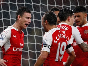 Laurent Koscielny (L) of Arsenal celebrates scoring his team's second goal with his team mates during the Barclays Premier League match between Arsenal and Everton at Emirates Stadium on October 24, 2015 in London, England. 