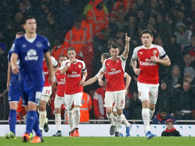 Arsenal's French defender Laurent Koscielny (2nd R) celebrates after scoring their second goal during the English Premier League football match between Arsenal and Everton at the Emirates Stadium in London on October 24, 2015. 