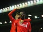 Christian Benteke (R) of Liverpool celebrates scoring his team's first goal with his team mate Roberto Firmino (L) during the Barclays Premier League match between Liverpool and Southampton at Anfield on October 25, 2015