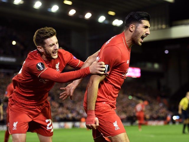 Emre Can (R) of Liverpool is congratulated by teammate Adam Lallana of Liverpool after scoring a goal to level the scores at 1-1 during the UEFA Europa League Group B match between Liverpool FC and Rubin Kazan at Anfield on October 22, 2015