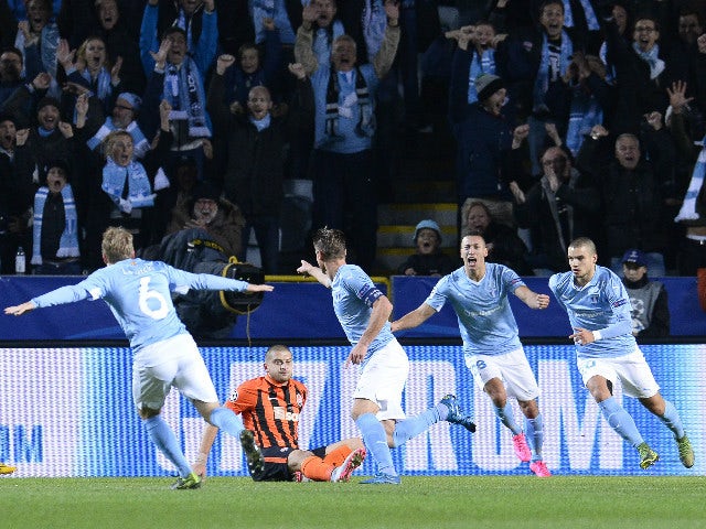 Malmo's Swedish forward Markus Rosenberg (C) celebrates with his teammates after scoring the opening goal during the UEFA Champions League Group A, first-leg football match between Malmo FF and FC Shakhtar Donetsk in Malmo, Sweden on October 21, 2015.