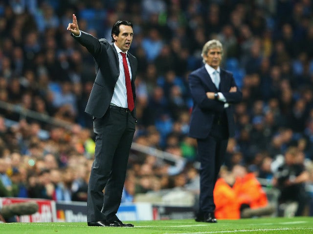 Unai Emery, coach of Sevilla gives instructions with Manuel Pellegrini, manager of Manchester City during the UEFA Champions League Group D match between Manchester City and Sevilla at Etihad Stadium on October 21, 2015 in Manchester, United Kingdom.