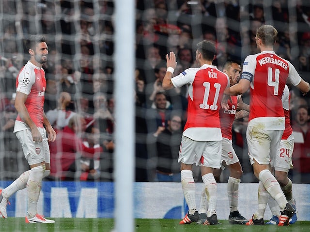 Arsenal's French striker Olivier Giroud (L) celebrates after scoring his team's first goal during the UEFA Champions League football match between Arsenal and Bayern Munich at the Emirates Stadium in London, on October 20, 2015.