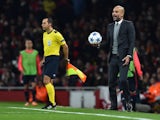 Bayern Munich's Spanish head coach Pep Guardiola reacts as he holds a ball that went out of play during the UEFA Champions League football match between Arsenal and Bayern Munich at the Emirates Stadium in London, on October 20, 2015. 