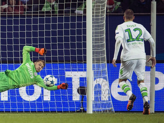 Wolfsburg's forward Bas Dost of the Netherlands (R) scores past PSV Eindhoven's goalkeeper Jeroen Zoet during the Group B, first-leg UEFA Champions League football match VfL Wolfsburg vs PSV Eindhoven in Wolfsburg, northern Germany on October 21, 2015.