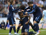 Real Madrid's Brazilian defender Danilo (C) is congratulated by teammates after scoring a goal during the Spanish league football match Celta Vigo vs Real Madrid CF at the Balaidos stadium in Vigo on October 24, 2015