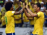 Brazil's Ricardo Oliveira (R) celebrates with teammate Willian after scoring against Venezuela during their Russia 2018 FIFA World Cup South American Qualifiers football match, at the Estadio Castelao stadium in Fortaleza, Brazil, on October 13, 2015.