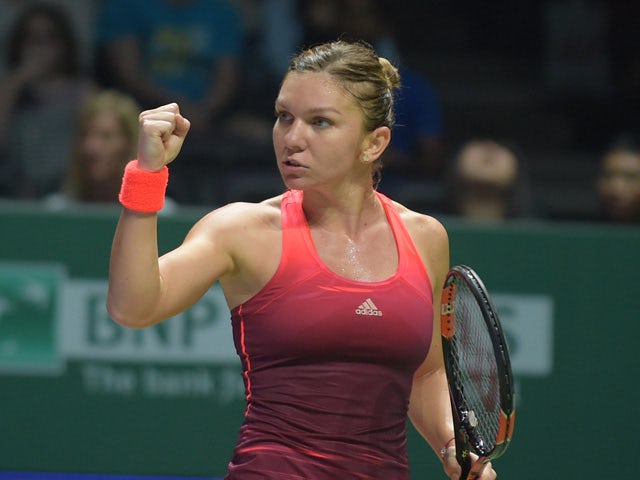 Simona Halep of Romania celebrates winning a point against Falvia Pennetta of Italy during their season-ending tennis WTA Final in Singapore on October 25, 2015