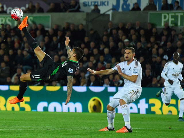 Joselu of Stoke City attempts an overhead kick as Angel Rangel of Swansea City challenges during the Barclays Premier League match between Swansea City and Stoke City at Liberty Stadium on October 19, 2015