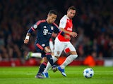 Thiago Alcantara of Bayern Munich is watched by Santi Cazorla of Arsenal during the UEFA Champions League Group F match between Arsenal FC and FC Bayern Munchen at Emirates Stadium on October 20, 2015 in London, United Kingdom. 