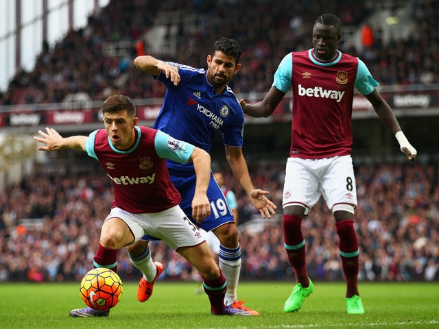 Aaron Cresswell of West Ham United and Diego Costa of Chelsea compete for the ball during the Barclays Premier League match between West Ham United and Chelsea at Boleyn Ground on October 24, 2015