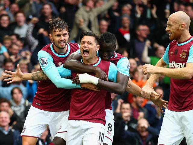 Mauro Zarate (2nd L) of West Ham United celebrates scoring his team's first goal with his team mates during the Barclays Premier League match between West Ham United and Chelsea at Boleyn Ground on October 24, 2015