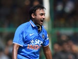 India's Amit Mishra (L) celebrates after bowling South Africa's Hashim Amla during the first one day international (ODI) cricket match between India and South Africa at Green Park Stadium in Kanpur on October 11, 2015