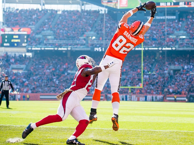 Tight end Gary Barnidge #82 of the Cleveland Browns catches a touchdown pass while under pressure from strong safety Tony Jefferson #22 of the Arizona Cardinals during the first half at FirstEnergy Stadium on November 1, 2015