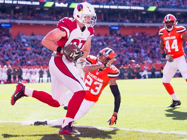 Tight end Troy Niklas #87 of the Arizona Cardinals scores on a pass from quarterback Carson Palmer #3 while under pressure from cornerback Joe Haden #23 of the Cleveland Browns during the first half at FirstEnergy Stadium on November 1, 2015