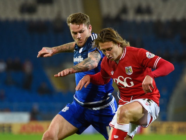 Bristol City player Luke Freeman (r) holds off the challenge of Aron Gunnarsson of Cardiff during the Sky Bet Championship match between Cardiff City and Bristol City at Cardiff City Stadium on October 26, 2015 in Cardiff, United Kingdom.