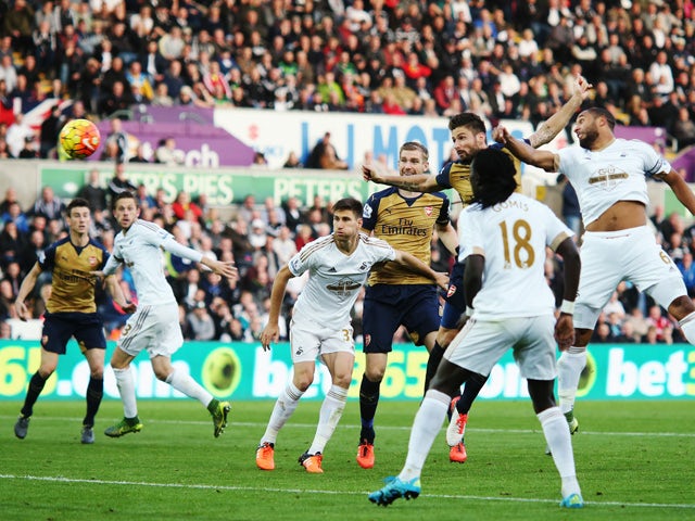 Olivier Giroud of Arsenal scores the opening goal during the Barclays Premier League match between Swansea City and Arsenal at Liberty Stadium on October 31, 2015