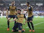 Olivier Giroud (C) of Arsenal celebrates scoring his team's first goal with his team mates Per Mertesacker (L) and Mesut Ozil (R) during the Barclays Premier League match between Swansea City and Arsenal at Liberty Stadium on October 31, 2015