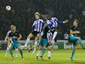 Lucas Joao (2nd R) of Sheffield Wednesday rises above the Arsenal defence to score his team's second goal during the Capital One Cup fourth round match between Sheffield Wednesday and Arsenal at Hillsborough Stadium on October 27, 2015 in Sheffield, Engla