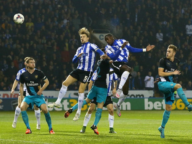 Lucas Joao (2nd R) of Sheffield Wednesday rises above the Arsenal defence to score his team's second goal during the Capital One Cup fourth round match between Sheffield Wednesday and Arsenal at Hillsborough Stadium on October 27, 2015 in Sheffield, Engla