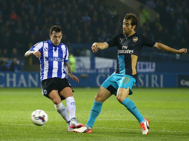 Ross Wallace of Sheffield Wednesday scores the opening goal despite the challenge from Mathieu Flamini of Arsenal during the Capital One Cup fourth round match between Sheffield Wednesday and Arsenal at Hillsborough Stadium on October 27, 2015 in Sheffiel