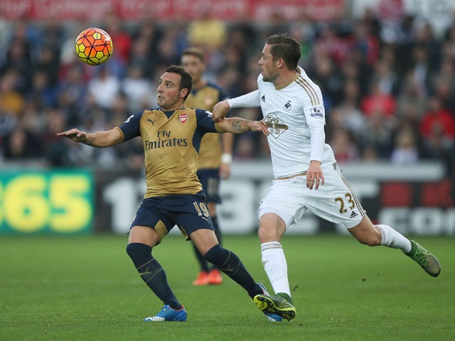 Santi Cazorla of Arsenal and Gylfi Sigurdsson of Swansea City compete for the ball during the Barclays Premier League match between Swansea City and Arsenal at Liberty Stadium on October 31, 2015